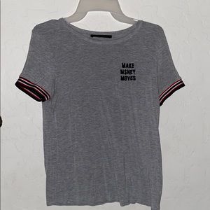 Gray shirt that says “Make Money Moves”